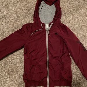 Maroon windbreaker.